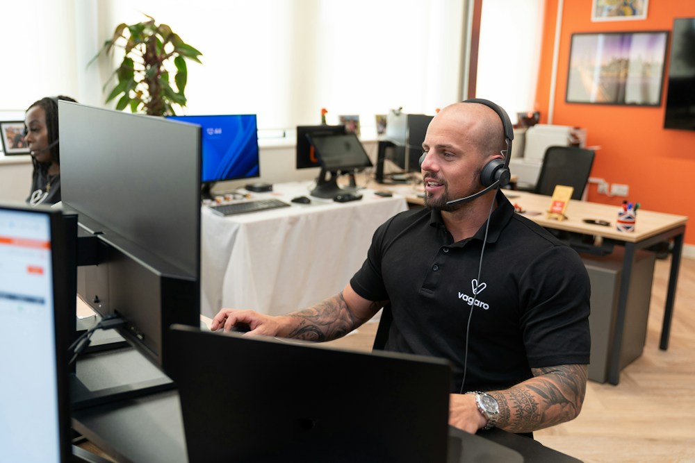 A customer support professional working with a headset